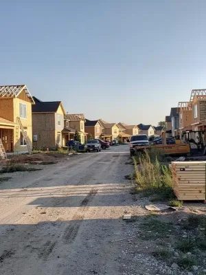 Residential construction site with fewer active projects, indicating a slowdown in housing starts.